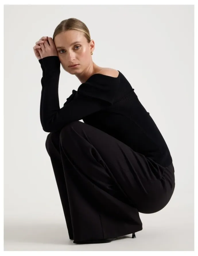 Blaq Asymmetrical Off The Shoulder Knit Top in Black